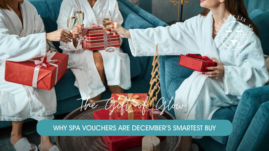 Three women in robes toasting champagne while exchanging gifts at day Spa Durban, celebrating with spa gift vouchers.